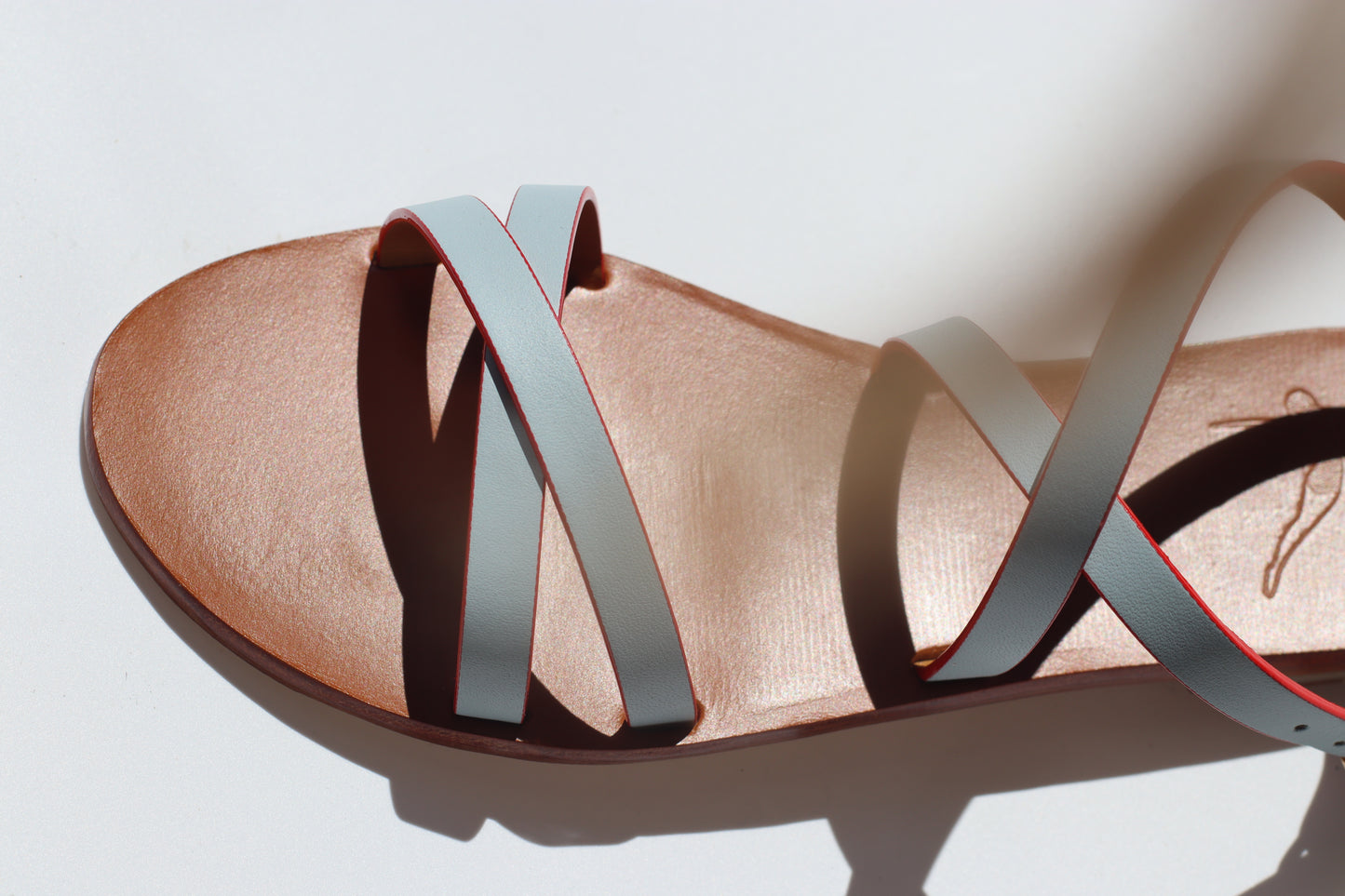 light blue flat sandal, studio photo