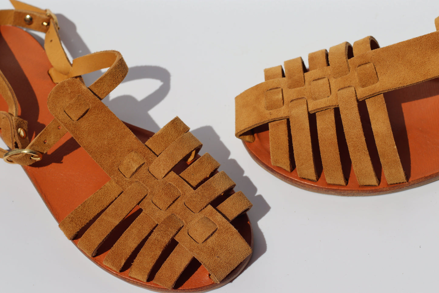 Side view of brown suede fisherman sandals with woven straps