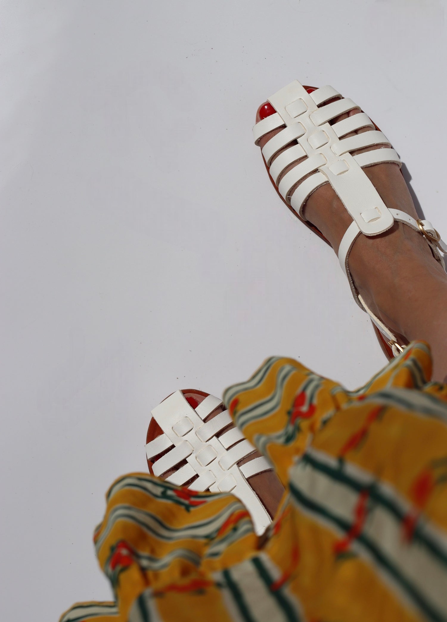 Photos of a woman wearing white fisherman sandals and a yellow skirt on a white background