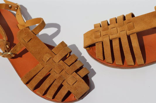 Side view of brown suede fisherman sandals with woven straps