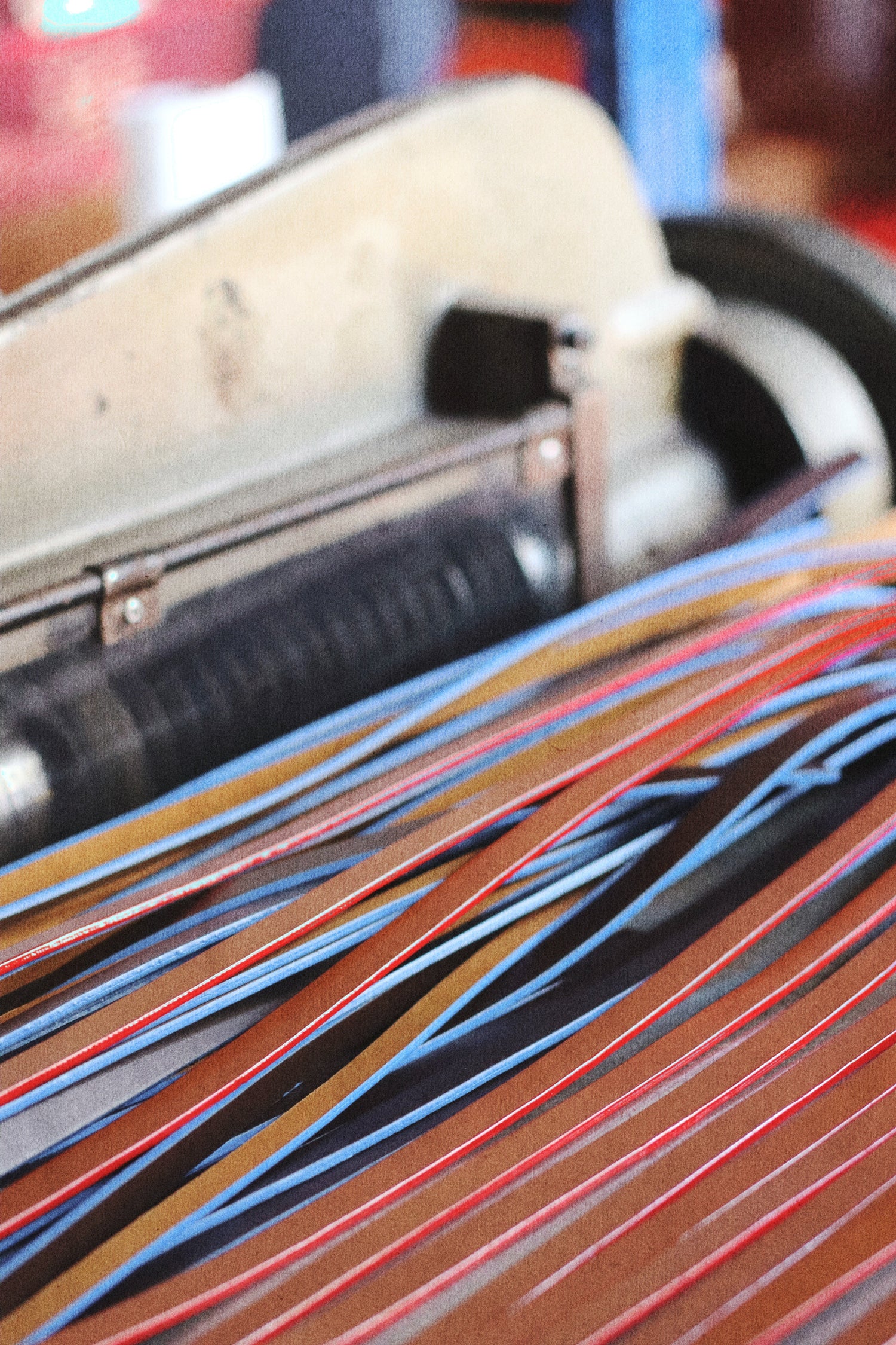 Close-up of a cutting machine with colorful wires and a blurred background