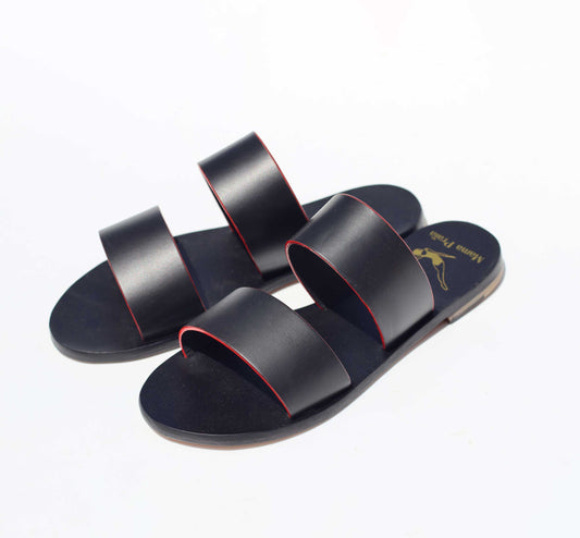 Black sandals with red accents on a white background