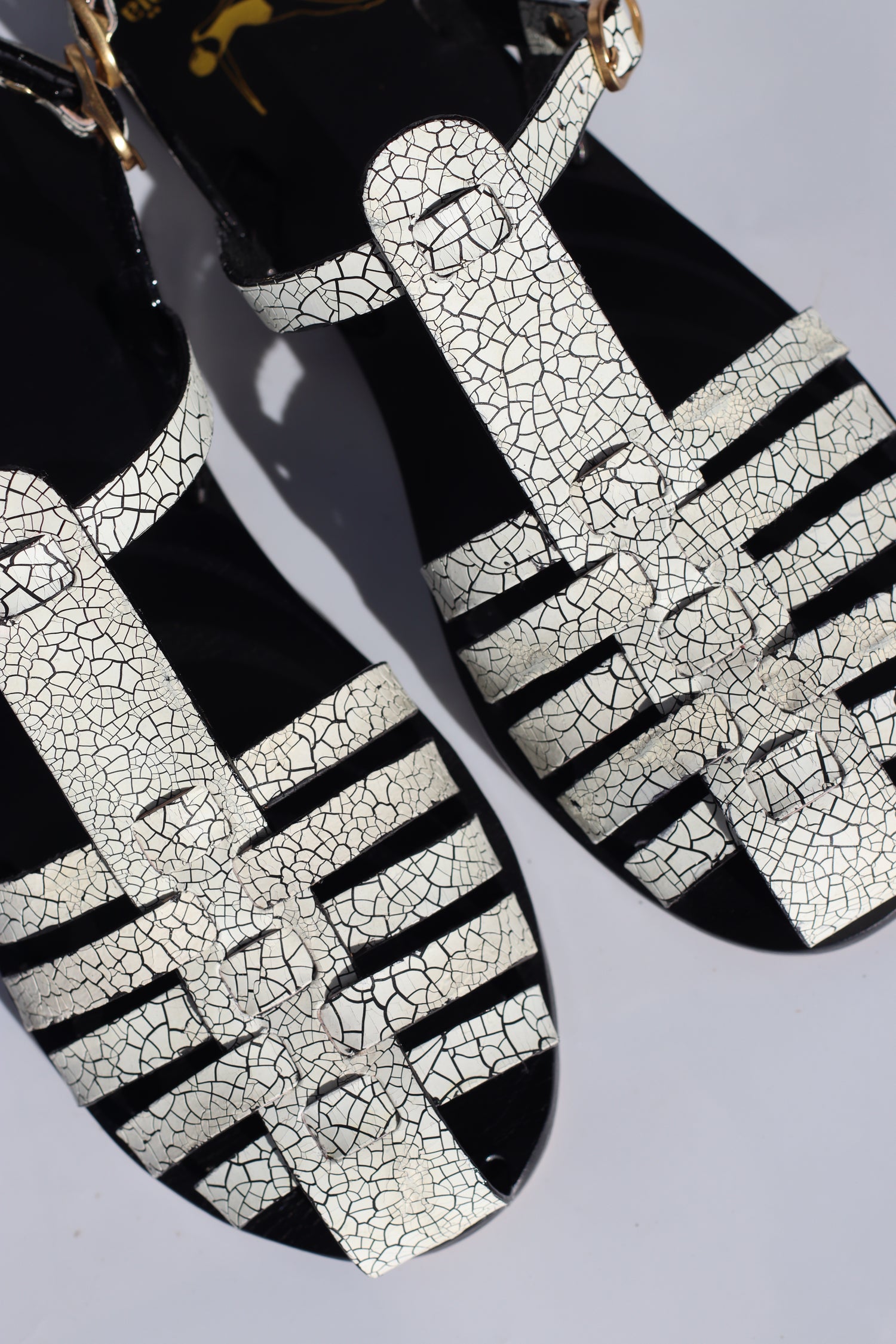 Black and white patterned shoes on a light gray background