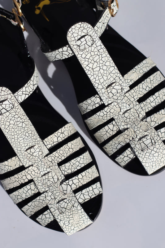 Black and white patterned shoes on a light gray background