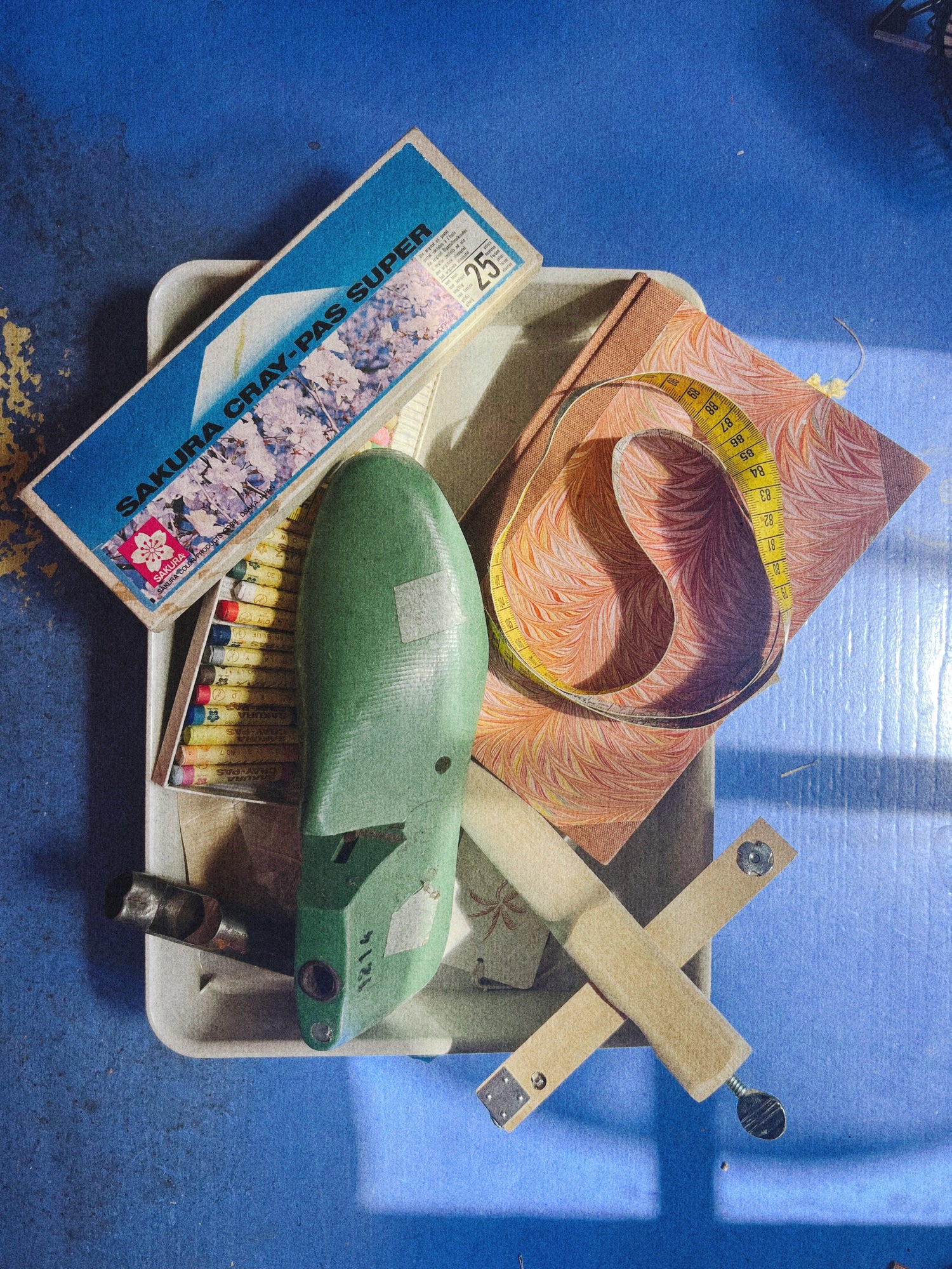 Collection of sewing tools and materials on a blue surface