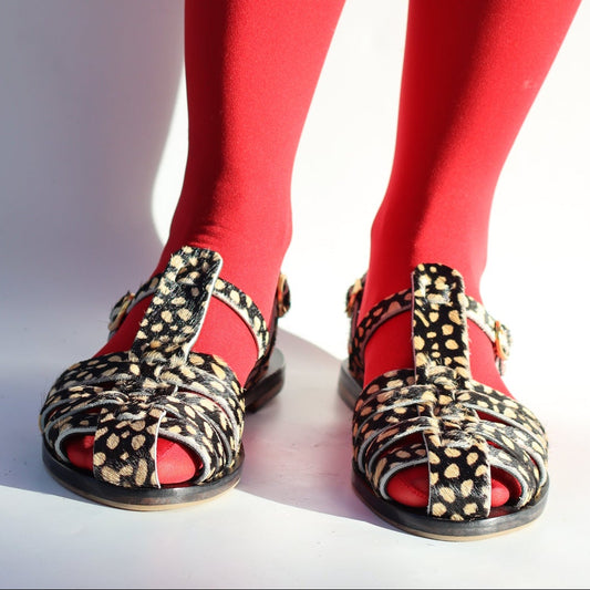 Red tights with decorative shoes on a white background